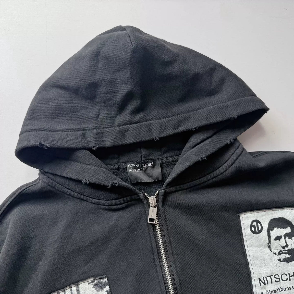 Distressed Patched Print Zip‑Up Hoodie